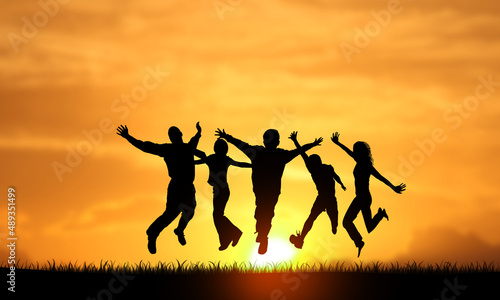 Very Happy Young Successful People Silhouettes Jumping Sunset background. Persons Team raised Arms. Success, joy, happiness a nd business Teamwork Concept 