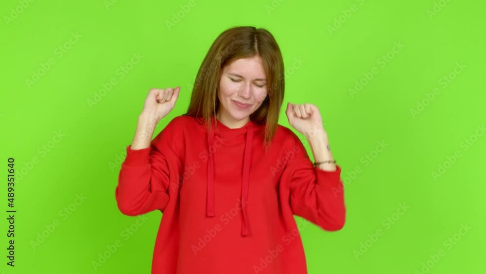 Young woman celebrating a victory and surprised to be successful over isolated background. Green screen chroma key Young woman celebrating a victory and surprised to be successful over isolated background. Green screen chroma key