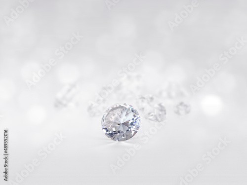 still with expensive cut diamonds in front of a white background, reflections on the ground. Lot of copyspace