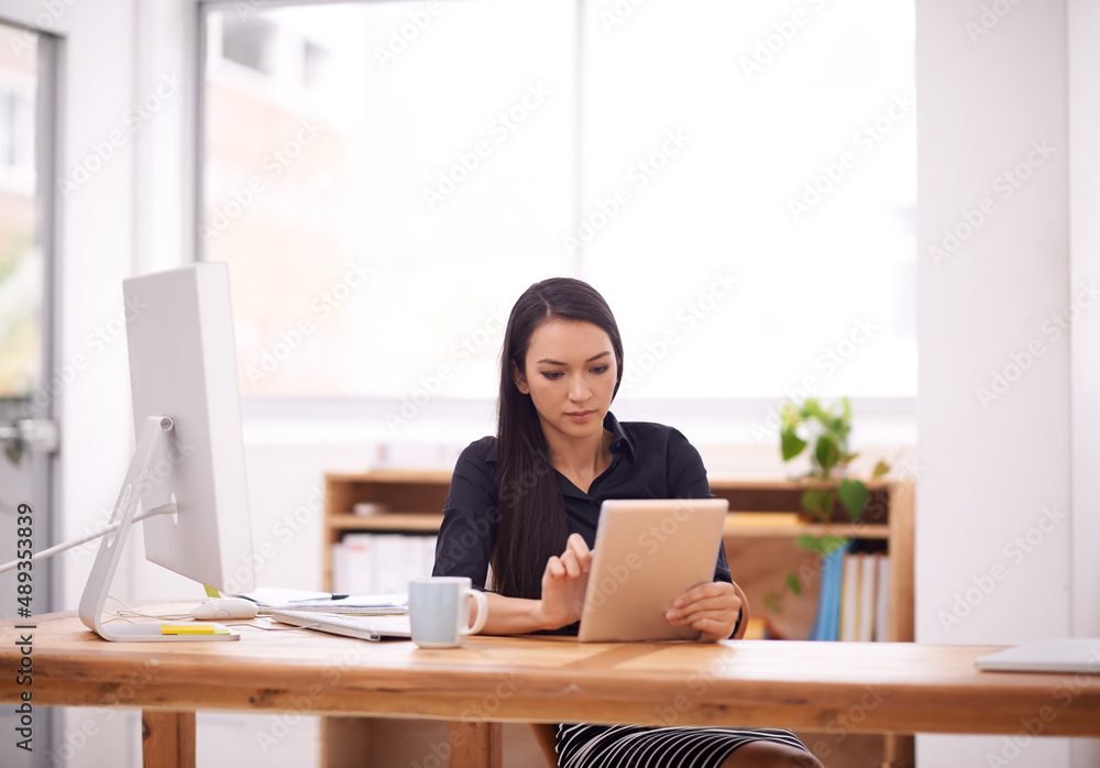 Living in a corporate world. Shot of a young businesswoman in her office. Living in a corporate world. Shot of a young businesswoman in her office.
