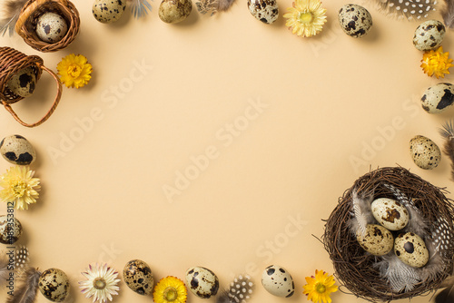 Top view of many eggs with brown spots cute feathers nest two small baskets and cute yellow beige and white flowers situated on isolated beige background with copyspace in the middle