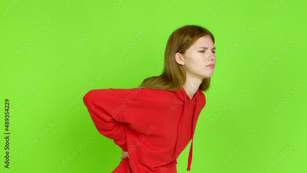 Young woman suffering from pain in shoulder for having made an effort over isolated background. Green screen chroma key Young woman suffering from pain in shoulder for having made an effort over isolated background. Green screen chroma key