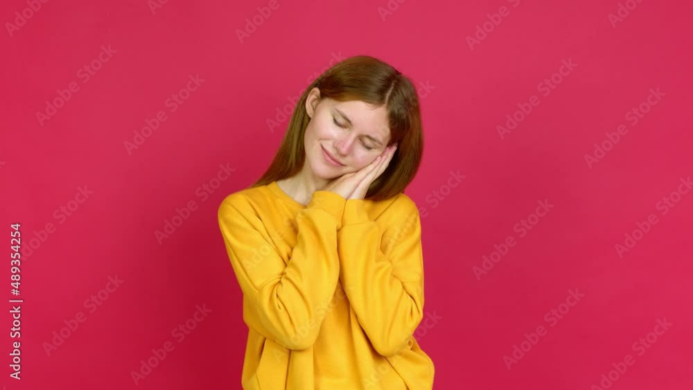 Young woman making sleep gesture. Adorable and sweet expression over isolated background
