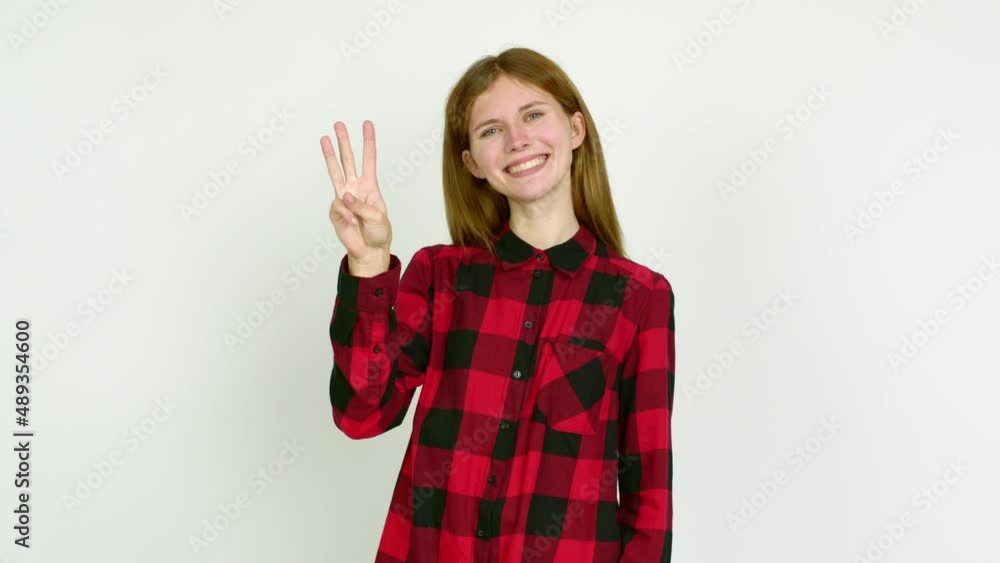 Young woman happy and counting with fingers over isolated background Young woman happy and counting with fingers over isolated background