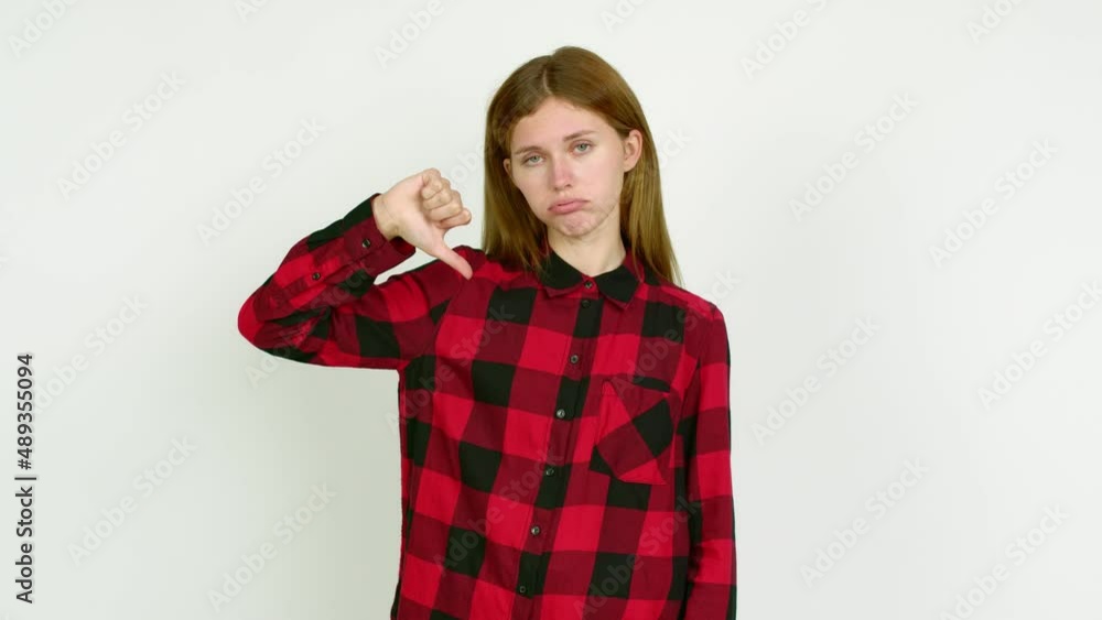 Young woman doing bad signal over isolated background Young woman doing bad signal over isolated background