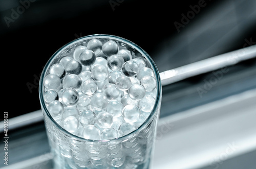 Hydrogel balls in a glass vase. Hydrogel as an art object or background for a computer desktop. Hydrogel close-up.