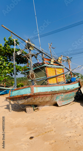 old and rotten fishing boat at a thailand beach