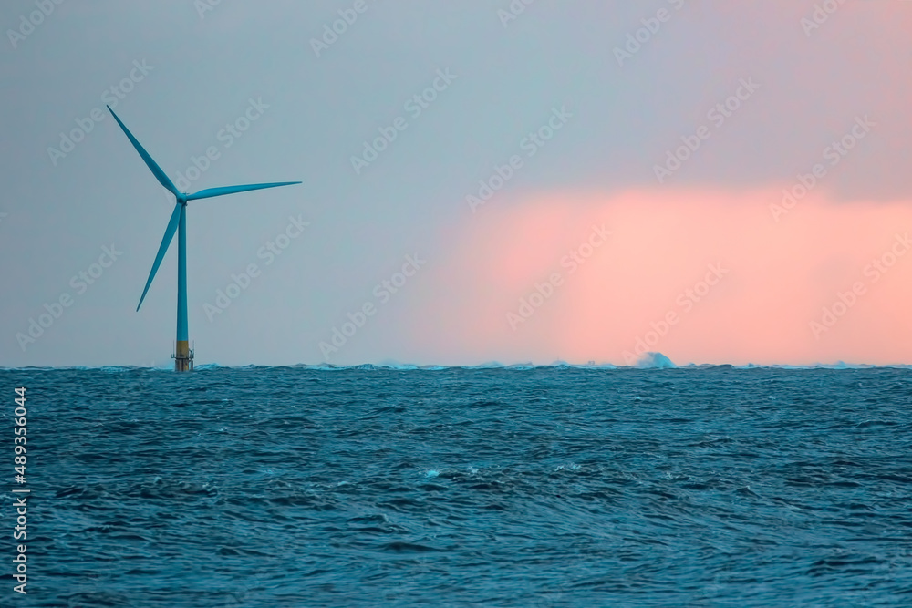 Single offshore wind turbine. Beautiful alternative energy landscape background image