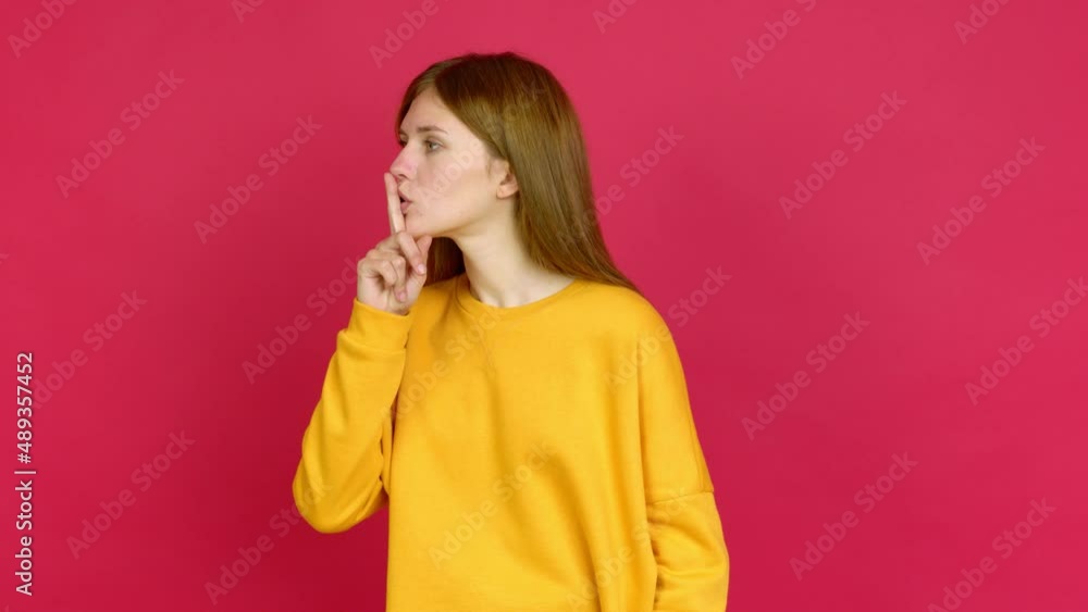 Young woman doing silence gesture over isolated background Young woman doing silence gesture over isolated background