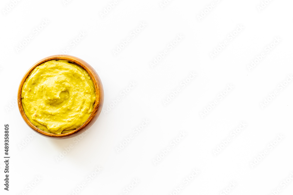 Green guacamole avocado dip in bowl, top view Green guacamole avocado dip in bowl, top view
