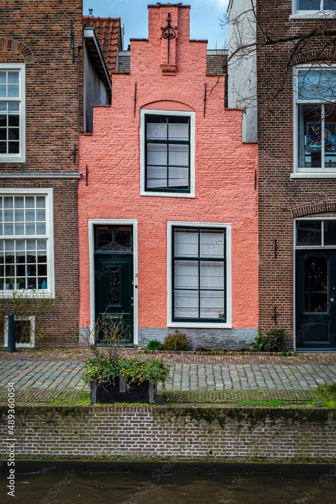 Canal Street view, with narrow pink traditional house Canal Street view, with narrow pink traditional house