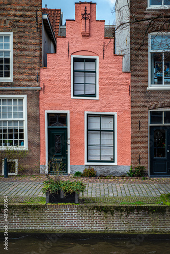 Canal Street view, with narrow pink traditional house