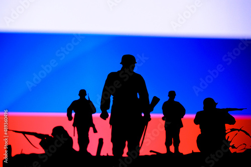 War in Ukraine. Russia attack Ukraine. Illustration Photo. Silhouette of Soldiers, National Flag in Background. Conflict in Europe photo