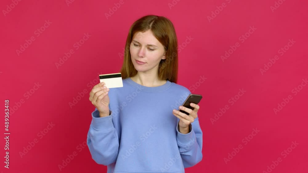 Young woman buying with the mobile over isolated background Young woman buying with the mobile over isolated background