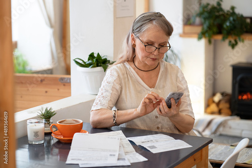 Elderly woman pays bills by phone