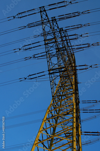 Fototapeta Silhouette of a high-voltage pylon in the blue evening sky.