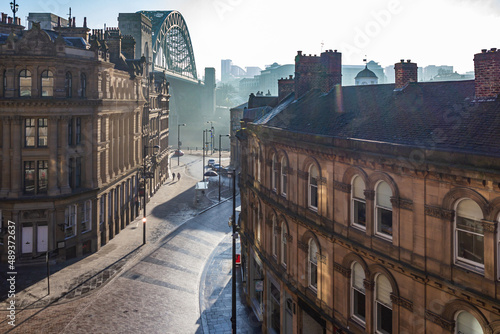 Newcastle Upon Tyne's famous Tyne Bridge and quayside in the historic Grainger Town part of the city, viewed from Queen Street at sunrise © Harry Green