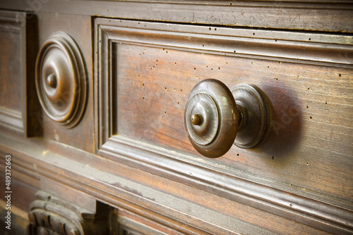 Photos Detail of an old knob turned wood with wooden surface and small holes damaged by
