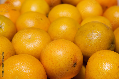 A bunch of yellow grapefruits close-up.