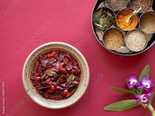 Fototapeta Naklejka Na Ścianę i Meble -  Grated beetroot curry with coconut and cashews with spices in Masala Dabba spice box. Indian cuisine.