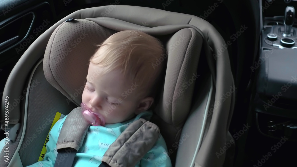 Portrait of sleeping little child in car seat with safety belt, enjoying road trip. Portrait of sleeping little child in car seat with safety belt, enjoying road trip.