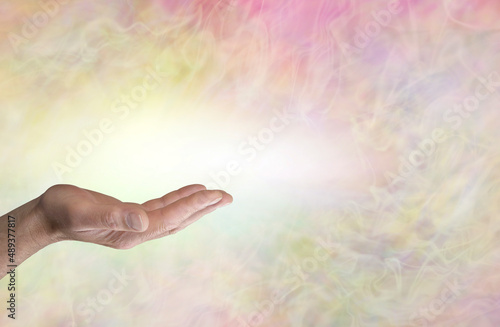 Add your own message male hand background - ideal for spiritual messages a warm pale  coloured wispy background with a male open palm hand and space for text
