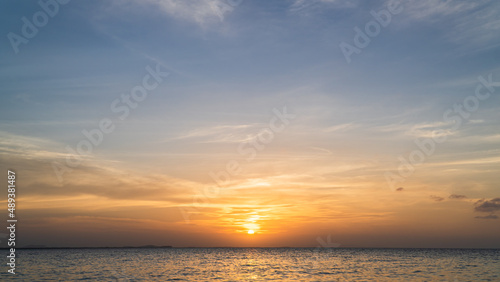 sunset over the sea in the evening with colorful orange sunlight clouds