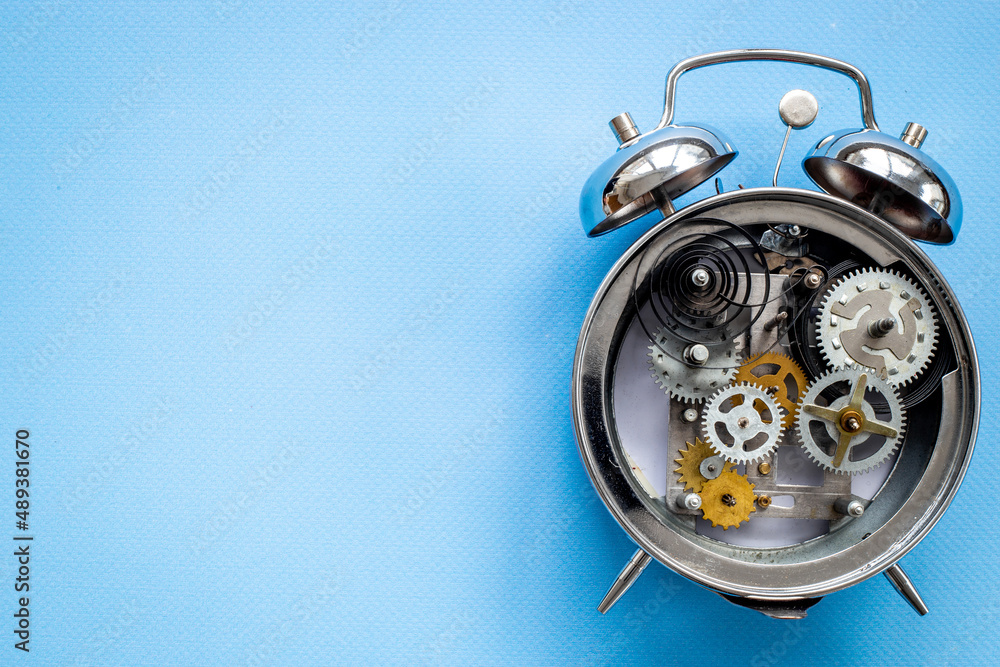 Fototapeta premium Watch mechanism with gears and wheels close up. Alarm clock mechanism