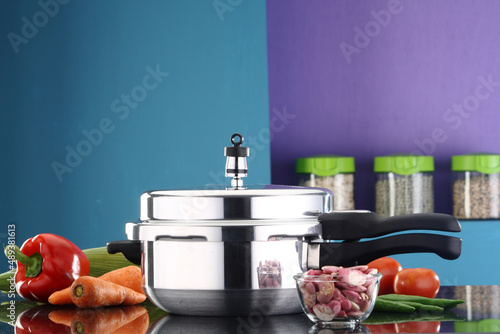 фотографія A pressure cooker and ingredients in a kitchen ambiance