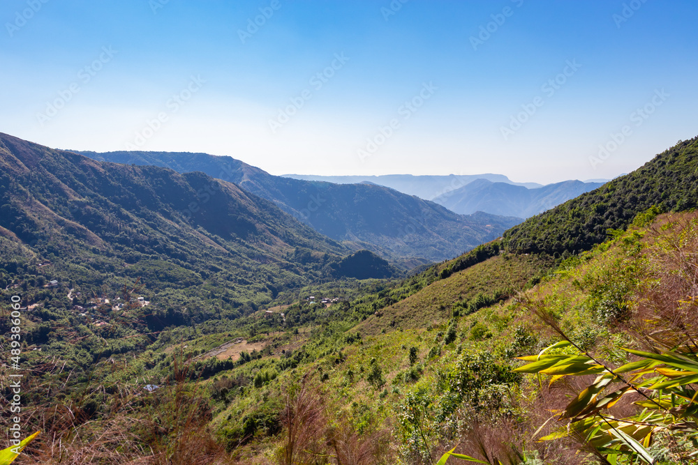 mountain range covered with dense green forests and bright blue sky at morning mountain range covered with dense green forests and bright blue sky at morning