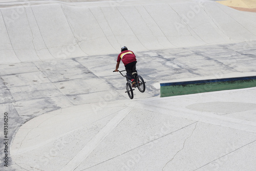 Boy man doing extreme sport doing tricks on bike bmx track