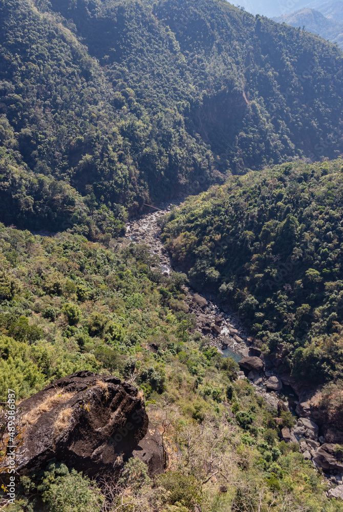 Fototapeta premium mountain river covered with green forests and misty blue sky at morning from flat angle