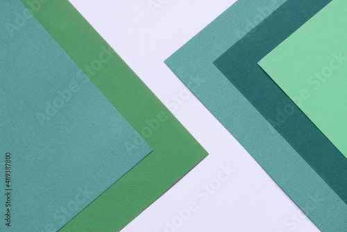 Multilayered colored cardstock background geometric design top view.