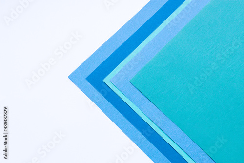 Multilayered colored cardstock background geometric design top view.