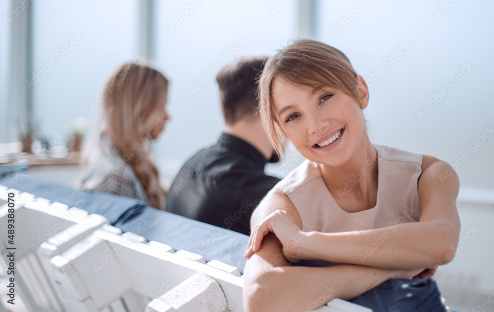 young business woman with Cup of coffee sitting in office lobby