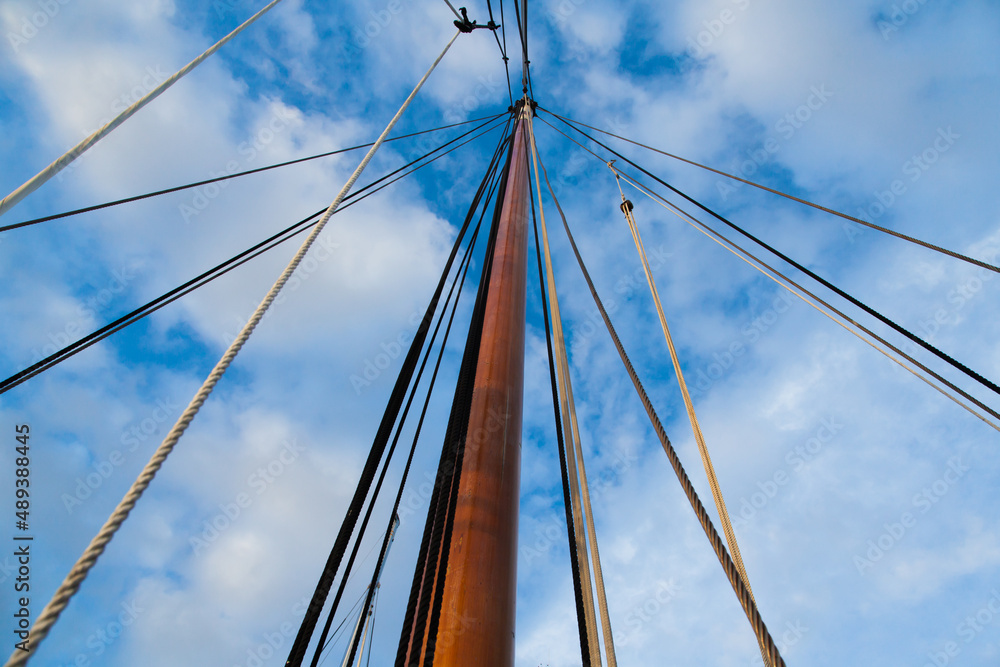 Mast of a sailing yacht without a sail. View from below. Mast of a sailing yacht without a sail. View from below.