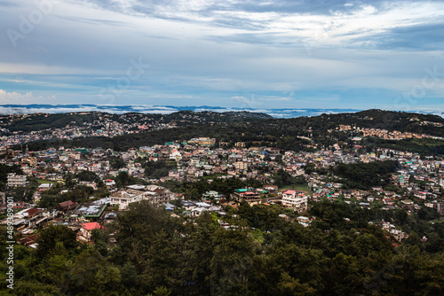 downtown city view with dramatic cloudy sky at evening from mountain top