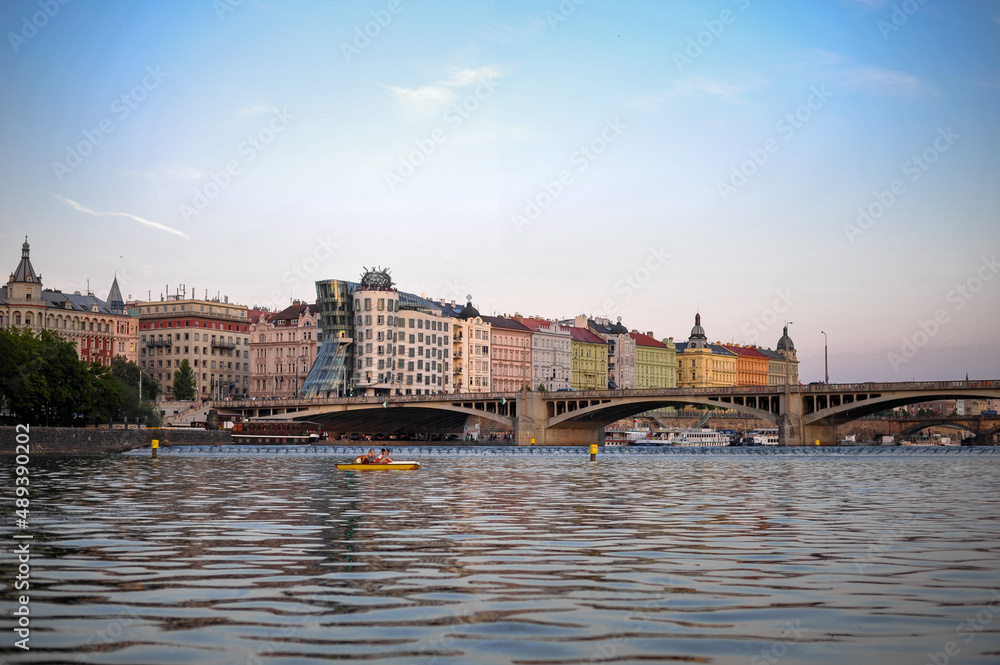 modern architecture dancing house of medieval Prague view from the surface of the vltava