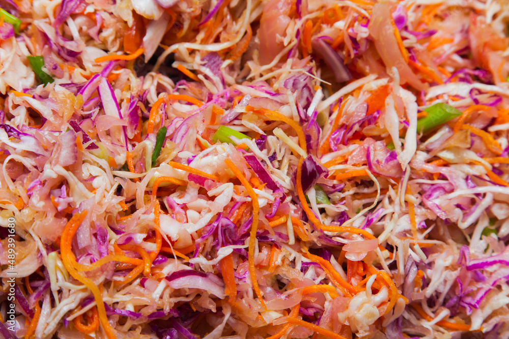 Fresh salad with cabbage, carrots and onions.