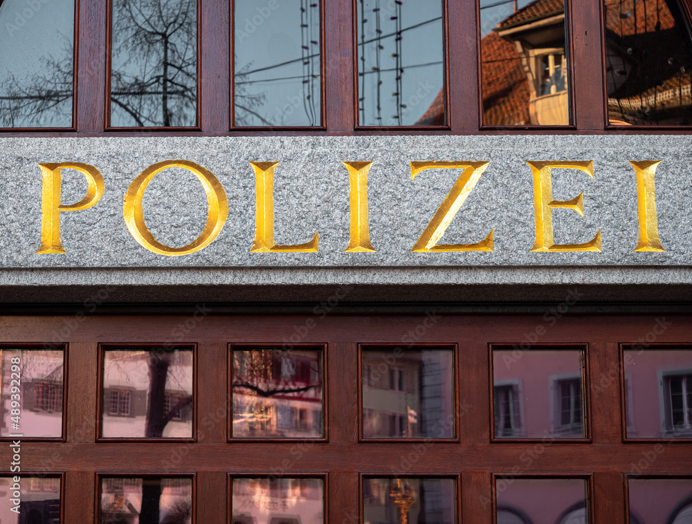 Zug, Switzerland - December 31, 2021: The window of the police station in Zug, Switzerland, with the german inscription Polizei - in translation Police