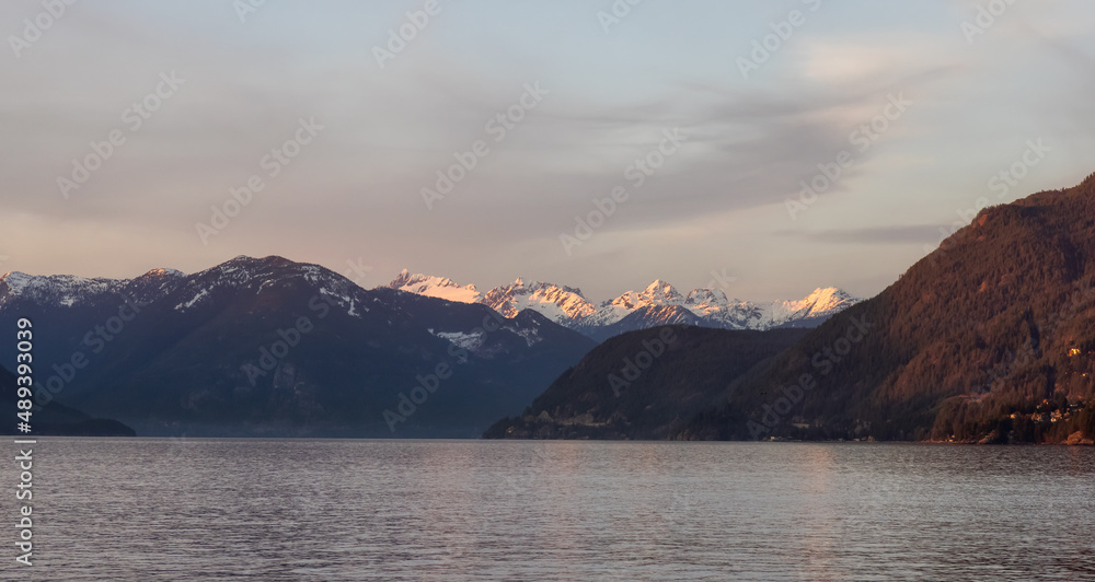 Canadian Nature Mountain Landscape on the Pacific Ocean West Coast. Colorful Winter Sunset. Taken in Howe Sound near Horseshoe Bay, West Vancouver, British Columbia, Canada. Background