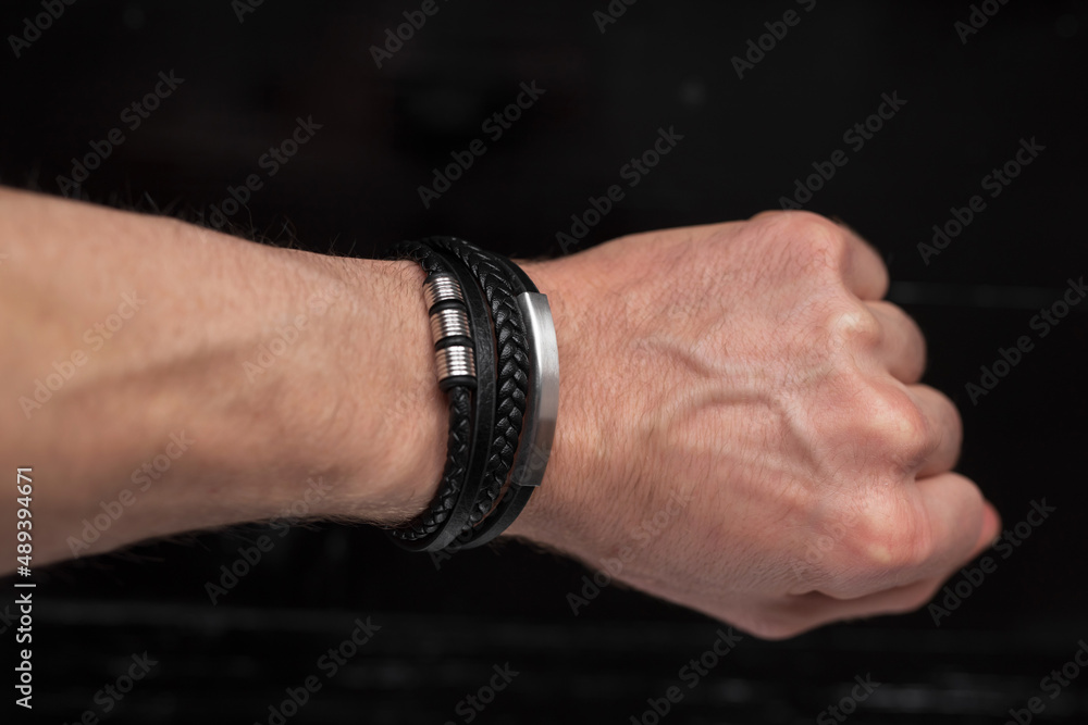 Black leather bracelet on the male hand