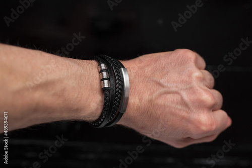Black leather bracelet on the male hand