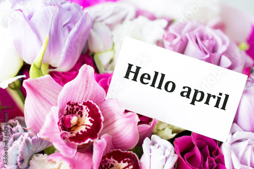 HELLO APRIL inscription on the card on a background of beautiful colors. April is coming, springtime concept