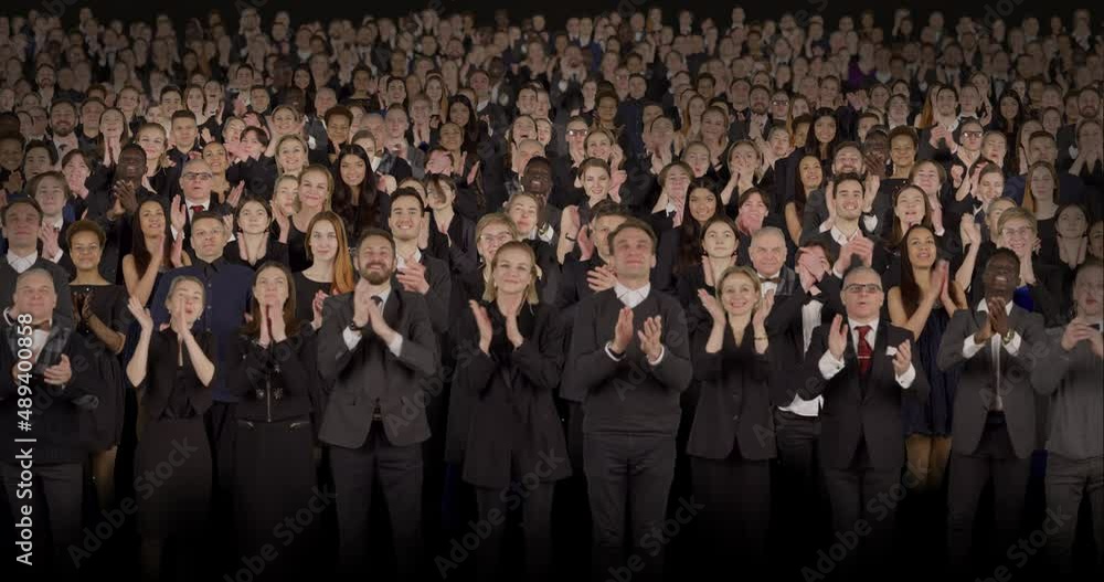 Front view of spectators wearing formal attire delivering standing ovations. Crowd background for theater, opera, ballet