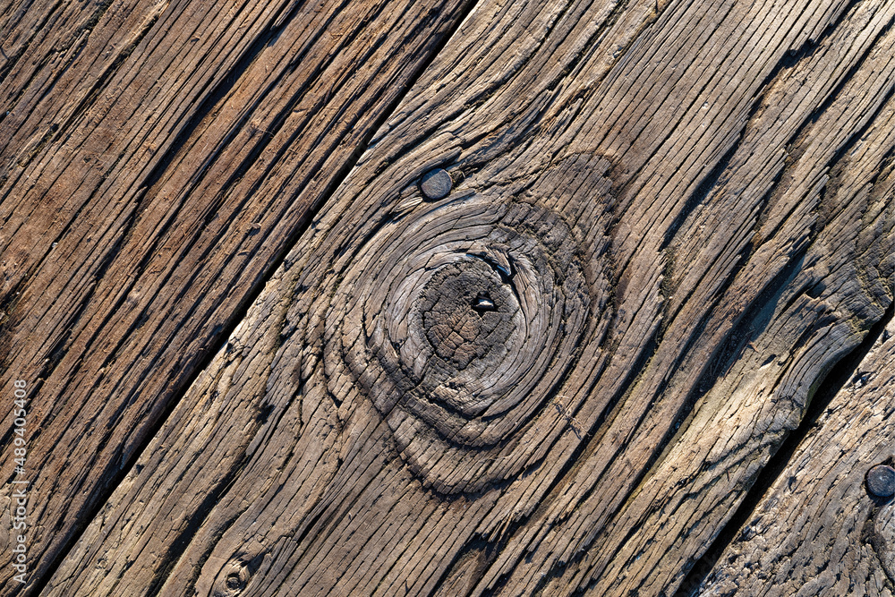 Naklejka premium A knot in the boardwalk at the Port of Siuslaw Marina in Florence, Oregon, USA