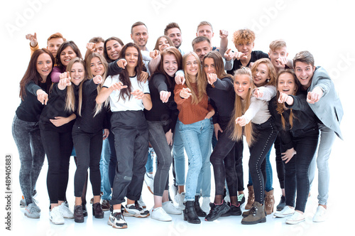 team of cheerful young people pointing at you