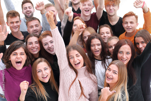 large group of happy young people looking at the camera