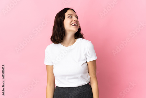 Teenager Ukrainian girl isolated on pink background laughing
