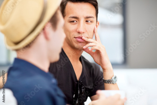 Talking to your best friend is sometimes all the therapy you need. Shot of a young man listening to his friend talk.